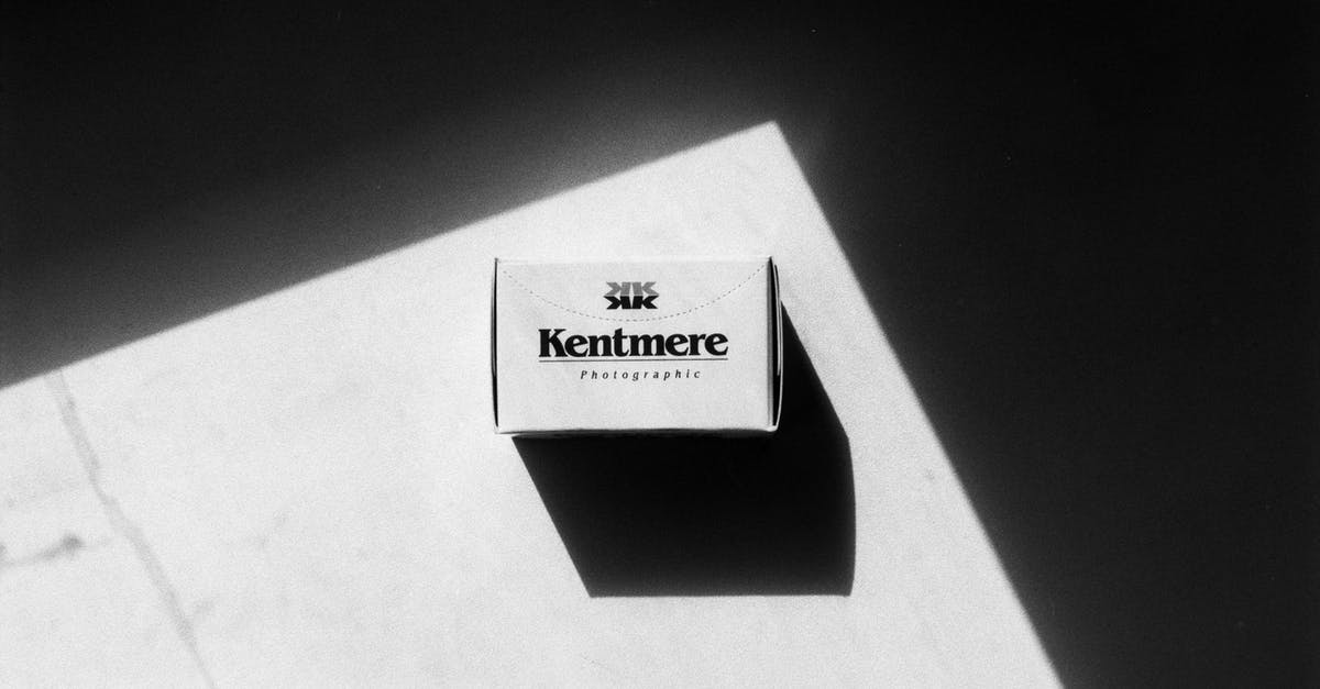 Is there room in overhead bins on CRJ900 for a roll-aboard? - Black and white top view of package of professional film with inscription placed on surface with bright sunlight and shadow