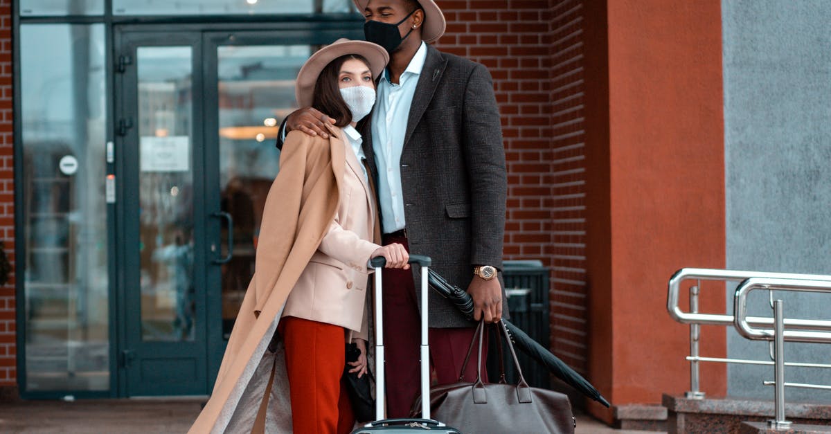 Is there somewhere I can store luggage (one or two normal suitcases) in San Francisco for a few days? - Man and Woman With Face Masks Waiting Outside A Building 