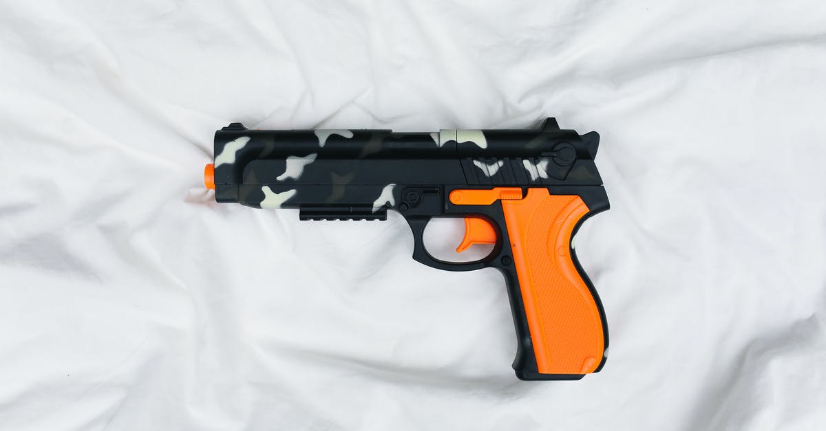 Is toy metal gun allowed on a Turkish Airways? - Black and Orange Semi Automatic Pistol on White Textile Is toy metal gun allowed on a Turkish Airways? - Black and Orange Semi Automatic Pistol on White Textile