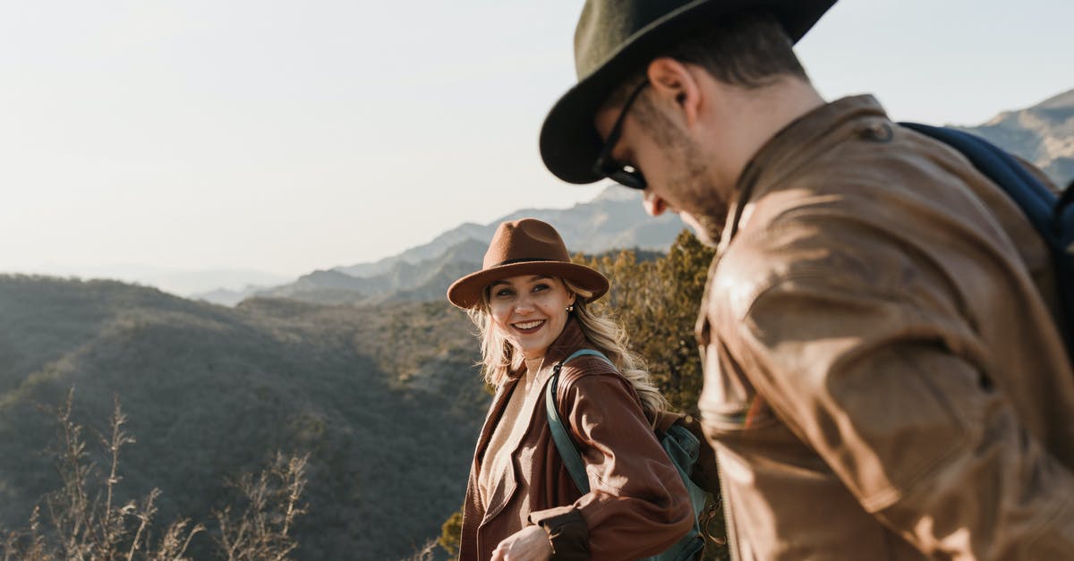 Is trekking safe in south Slavic countries? - Happy couple standing on grassy hilltop in sunny nature Is trekking safe in south Slavic countries? - Happy couple standing on grassy hilltop in sunny nature