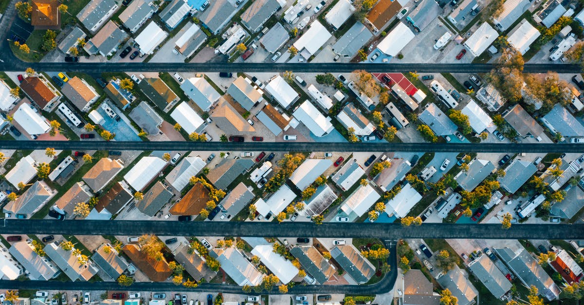 Islands and similar where visitors cannot take a car - Aerial view of residential buildings near road in small town Islands and similar where visitors cannot take a car - Aerial view of residential buildings near road in small town