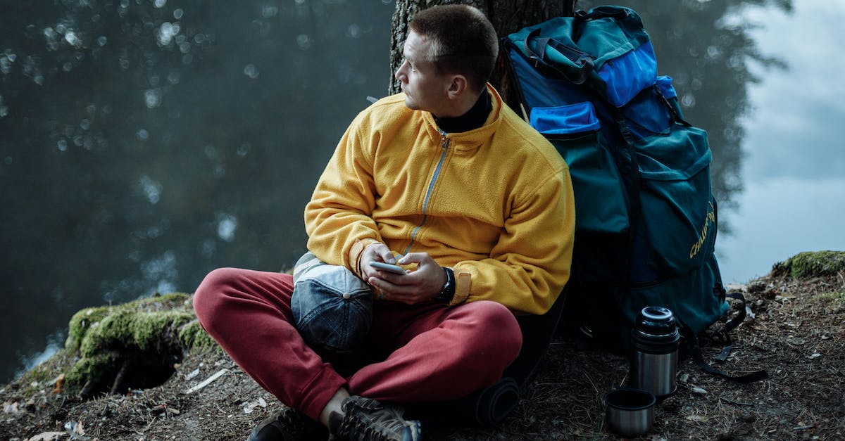 Issues when camping during trek in Georgia? - Man in Yellow Sweater and Red Pants Sitting on Ground Issues when camping during trek in Georgia? - Man in Yellow Sweater and Red Pants Sitting on Ground
