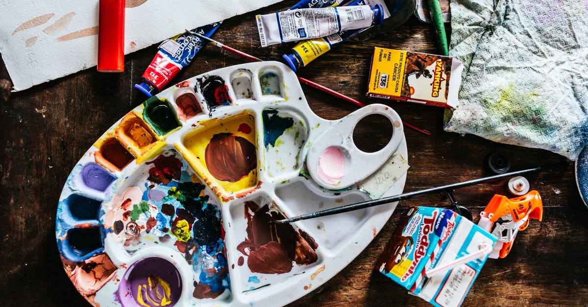 Item for removing stuff from headphone jack on a plane? - Top view of various art supplies including paintbrushes with colorful tubes of paint and palette placed on wooden table Item for removing stuff from headphone jack on a plane? - Top view of various art supplies including paintbrushes with colorful tubes of paint and palette placed on wooden table