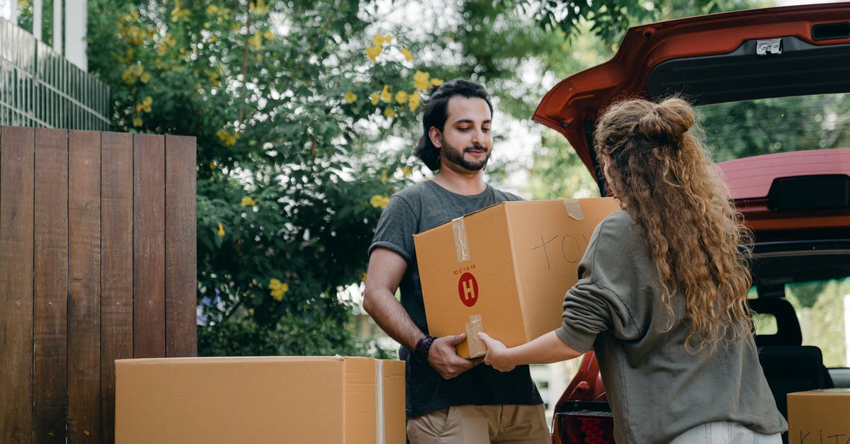 Itinerary changed and new airline introduced - Boyfriend and girlfriend in casual wear helping each other with unpacking car while moving in together on sunny summer day Itinerary changed and new airline introduced - Boyfriend and girlfriend in casual wear helping each other with unpacking car while moving in together on sunny summer day