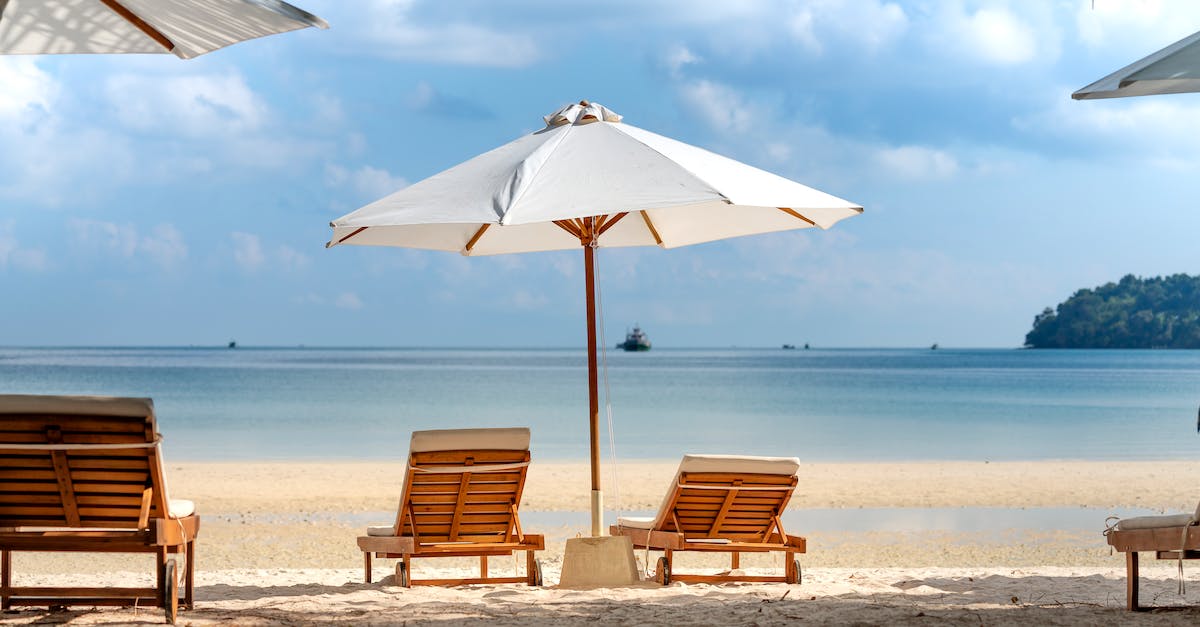Jeju Island (New Natural Wonder of the World) - How to Get There? - Tropical beach with deckchairs and umbrella Jeju Island (New Natural Wonder of the World) - How to Get There? - Tropical beach with deckchairs and umbrella