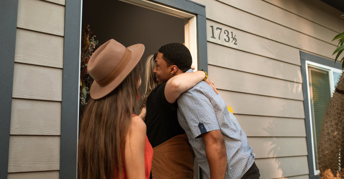Jewish person visiting American friend in Qatar - A Person Hugging a Man at the Doorway Jewish person visiting American friend in Qatar - A Person Hugging a Man at the Doorway