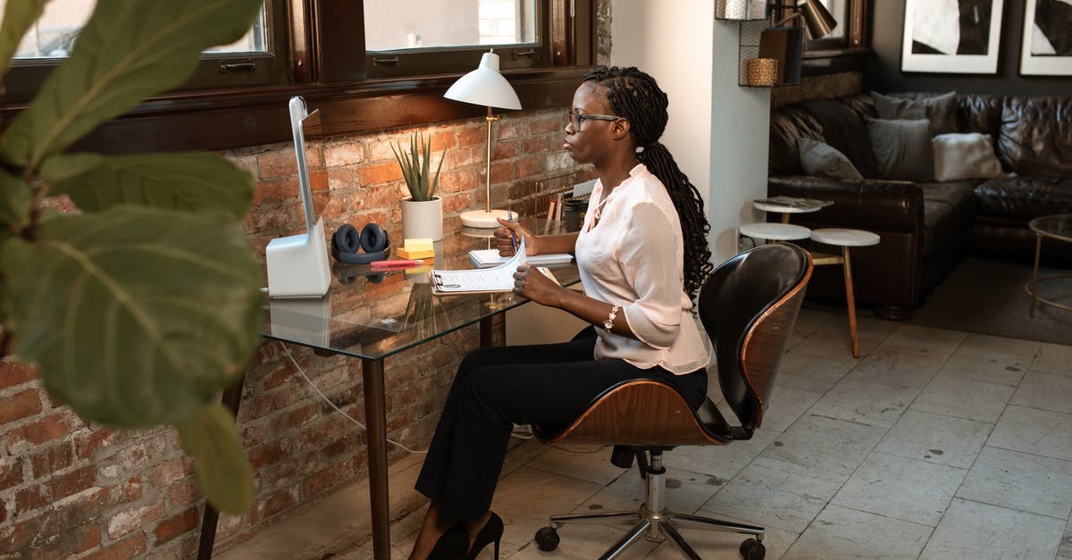 Job interview in London requires me to wire money to the travel agent. Is this a scam? - Woman in White Long Sleeve Shirt Sitting on Black Chair Job interview in London requires me to wire money to the travel agent. Is this a scam? - Woman in White Long Sleeve Shirt Sitting on Black Chair