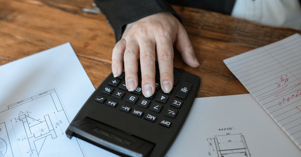 Job interview in London requires me to wire money to the travel agent. Is this a scam? - Person Holding Black Desk Calculator Job interview in London requires me to wire money to the travel agent. Is this a scam? - Person Holding Black Desk Calculator