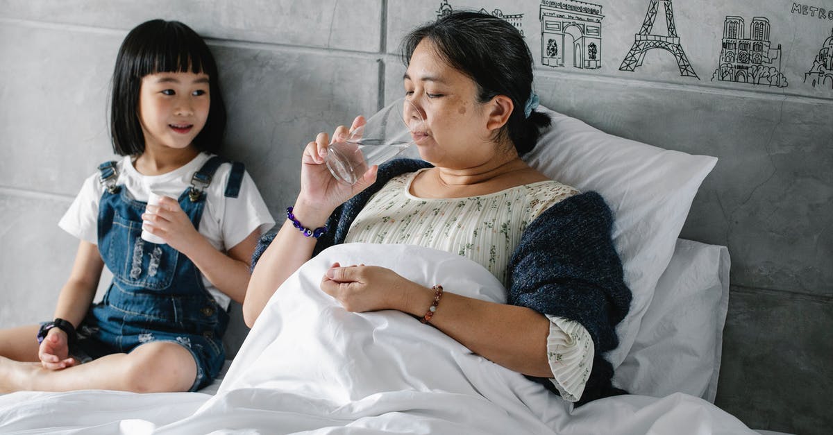 Just what is unhealthy in the water in Mexico? - Adorable ethnic child giving pills to unhealthy grandmother drinking water in bed Just what is unhealthy in the water in Mexico? - Adorable ethnic child giving pills to unhealthy grandmother drinking water in bed