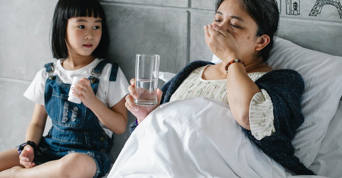 Just what is unhealthy in the water in Mexico? - Cute Asian little girl sitting on soft bed and looking at sick grandmother drinking medicine on sunny day Just what is unhealthy in the water in Mexico? - Cute Asian little girl sitting on soft bed and looking at sick grandmother drinking medicine on sunny day