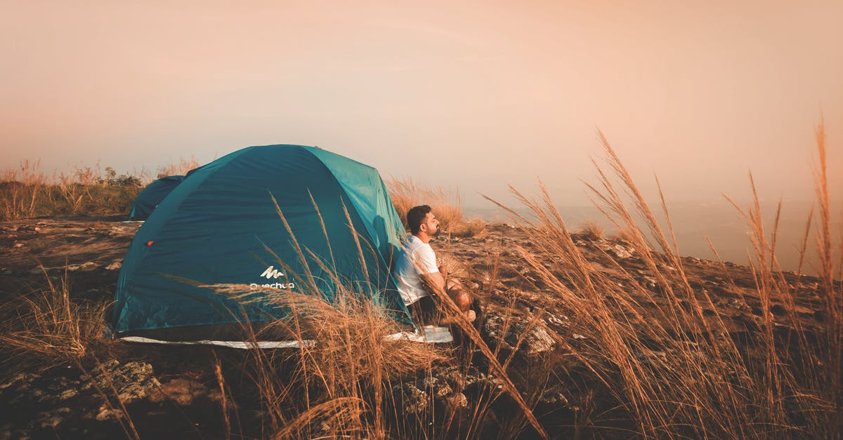 Karaoke for solo travellers - Photo of a Man Sitting Outside the Tent