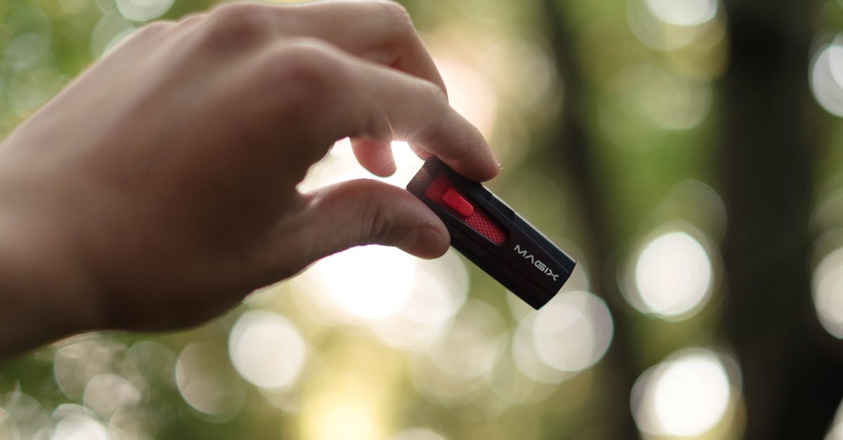 Key storage for later pickup at Brussels Airport - Unrecognizable person showing USB on blurred background Key storage for later pickup at Brussels Airport - Unrecognizable person showing USB on blurred background