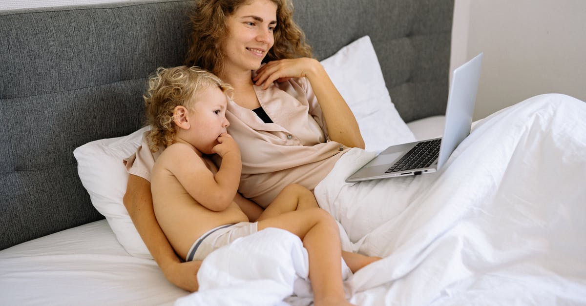 Killer Whale watching around Narvik End of October - A Mother and a Toddler Watching on a Laptop while Sitting on the Bed Killer Whale watching around Narvik End of October - A Mother and a Toddler Watching on a Laptop while Sitting on the Bed