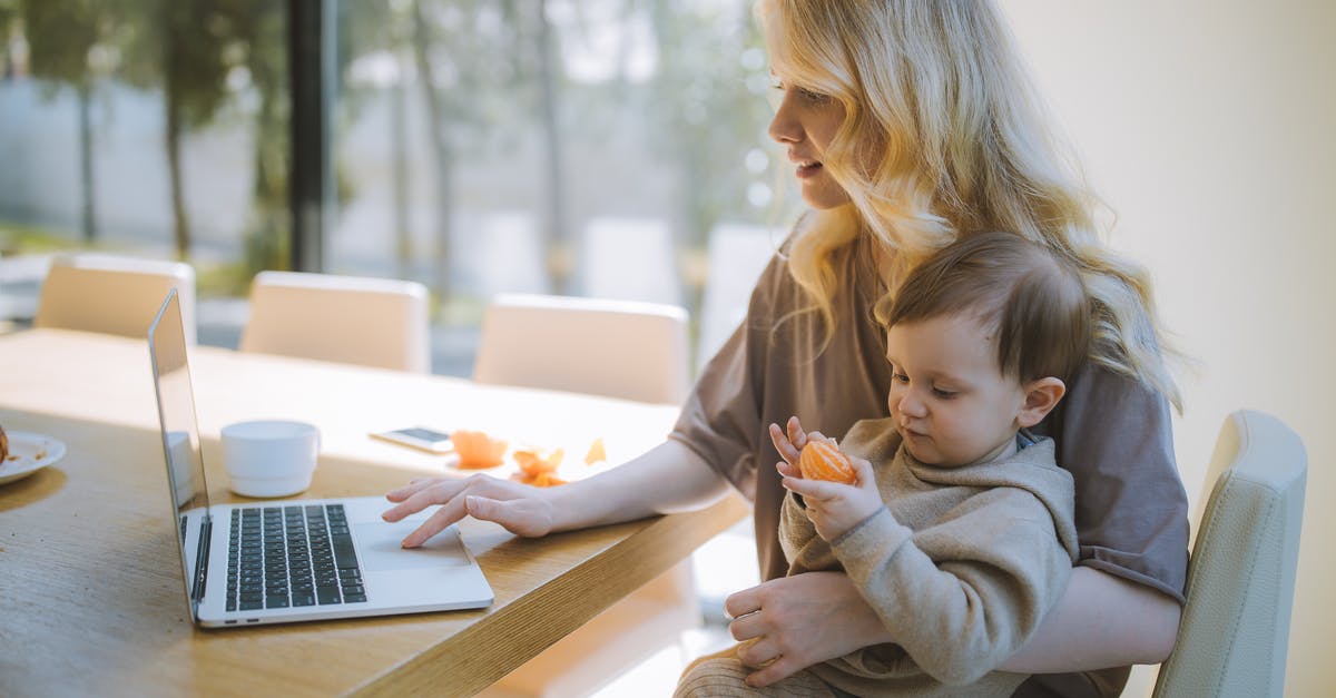 KLM 787-9 business seating for family - Woman Carrying her Baby and Working on a Laptop KLM 787-9 business seating for family - Woman Carrying her Baby and Working on a Laptop