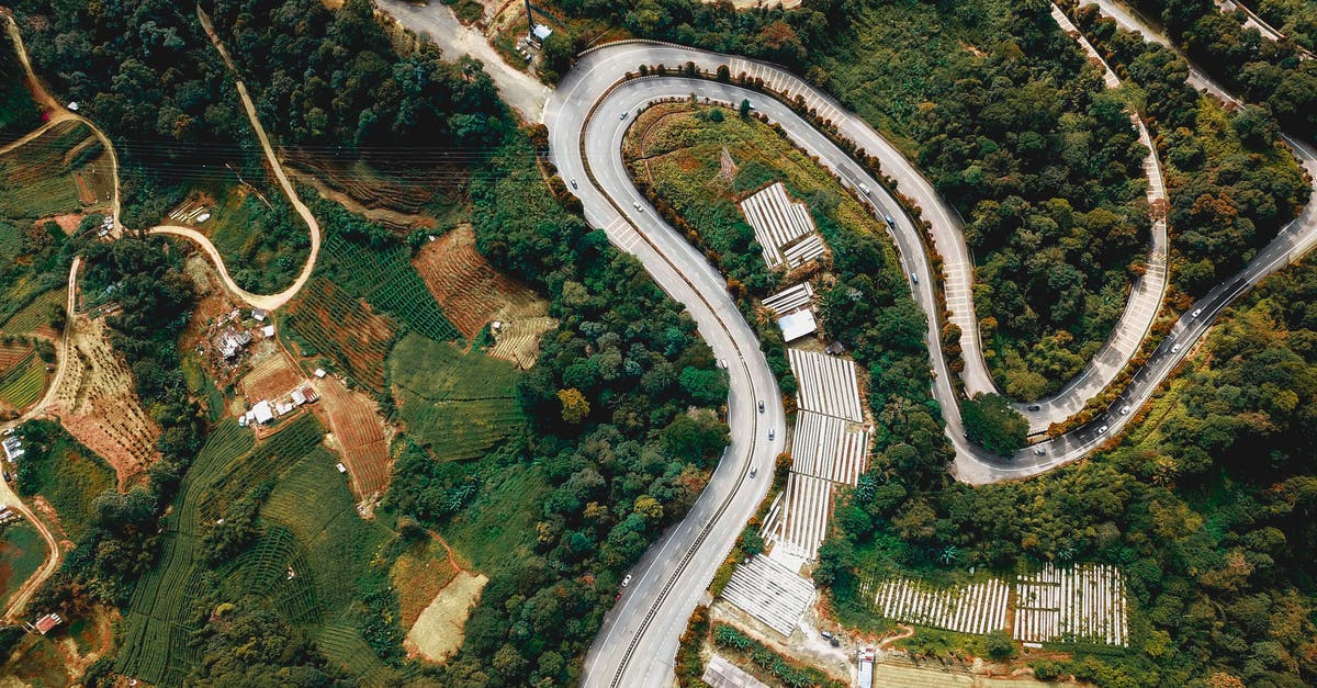 Land route from Chennai, Tamil Nadu to Amritsar, Punjab in India - Curve road through green forest in countryside Land route from Chennai, Tamil Nadu to Amritsar, Punjab in India - Curve road through green forest in countryside