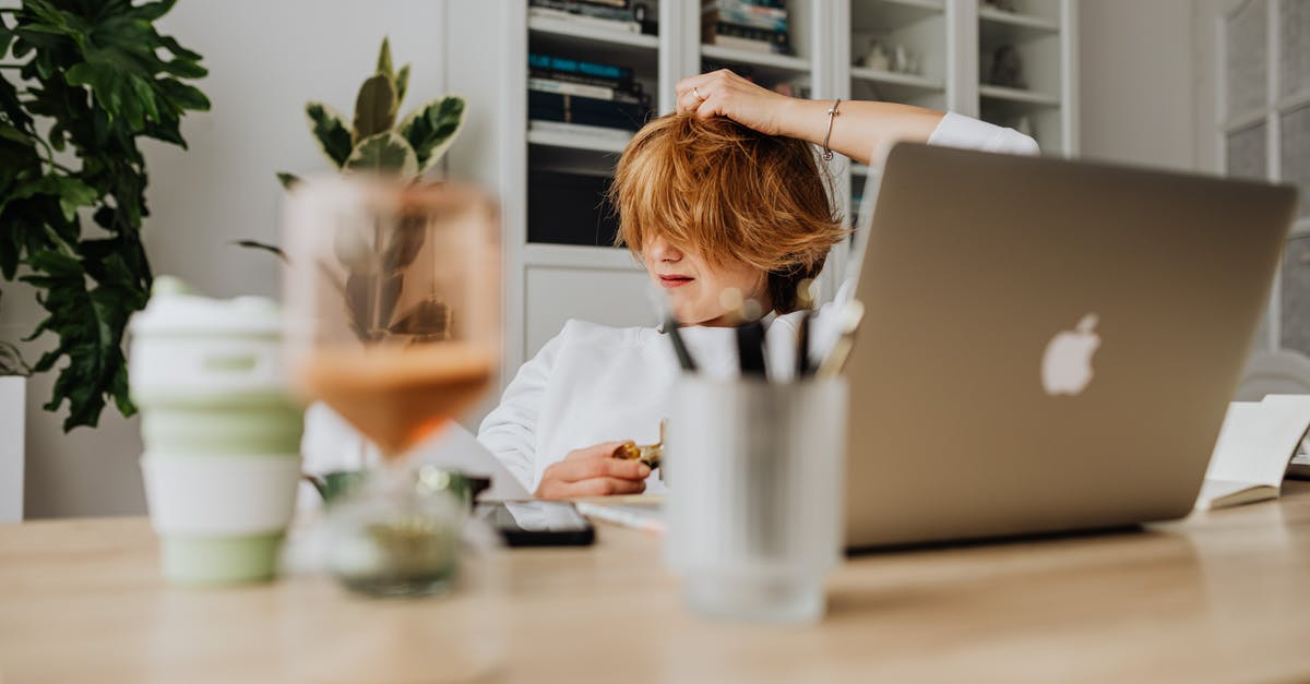 Laptop w/o battery US bound flight? - Teenager Sitting by Table in Home Off Laptop w/o battery US bound flight? - Teenager Sitting by Table in Home Off