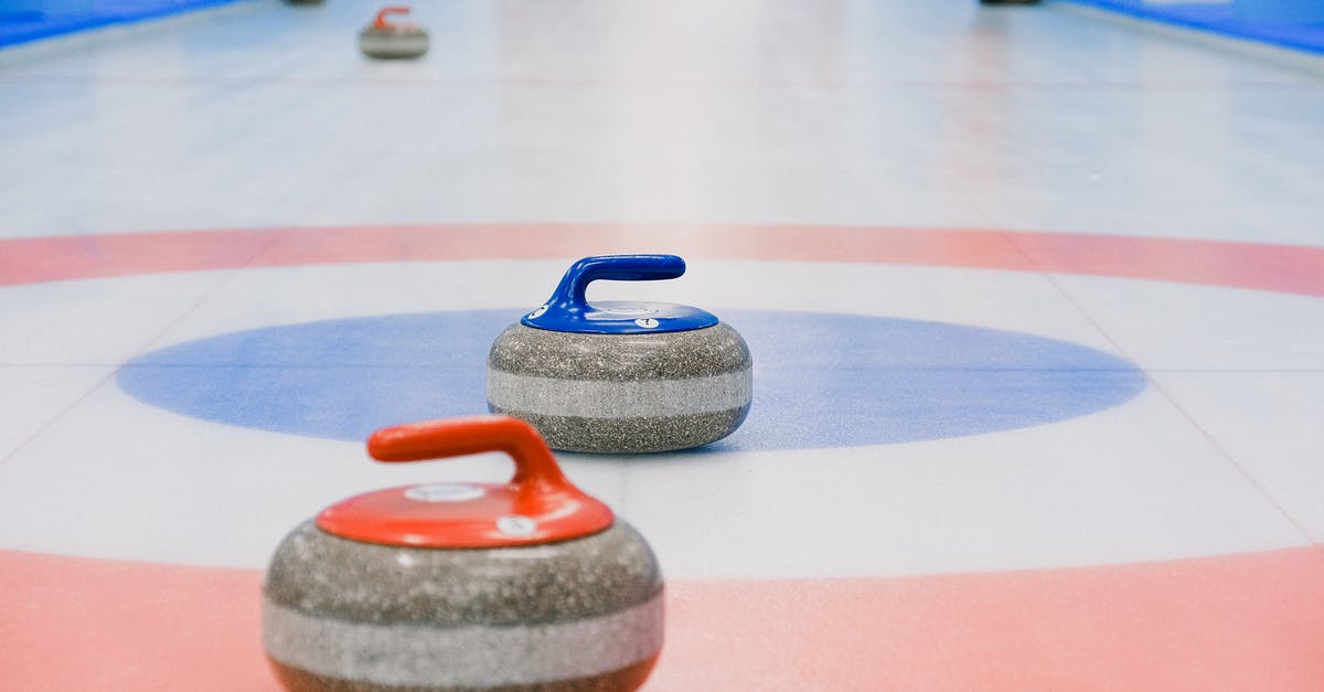 Last minute event tickets for London 2012 Olympic Games - Red and blue handled curling stones placed on circles of house of ice arena while competition Last minute event tickets for London 2012 Olympic Games - Red and blue handled curling stones placed on circles of house of ice arena while competition