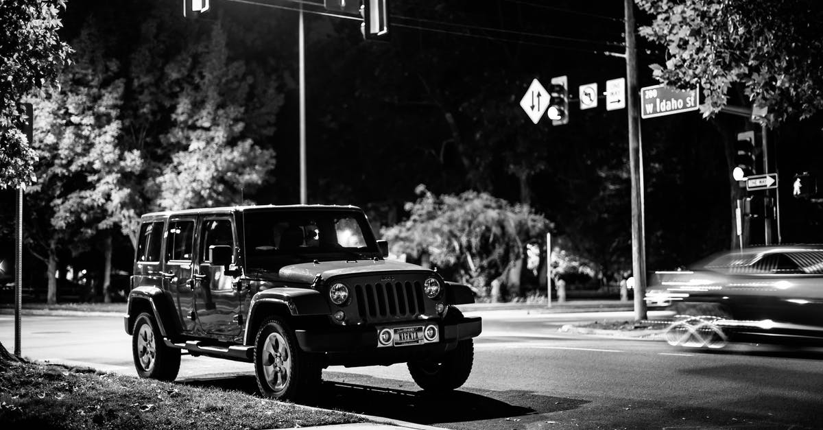 Late evening public transport in Nice - Black and white of contemporary automobile near crossroad with signposts in late evening Late evening public transport in Nice - Black and white of contemporary automobile near crossroad with signposts in late evening