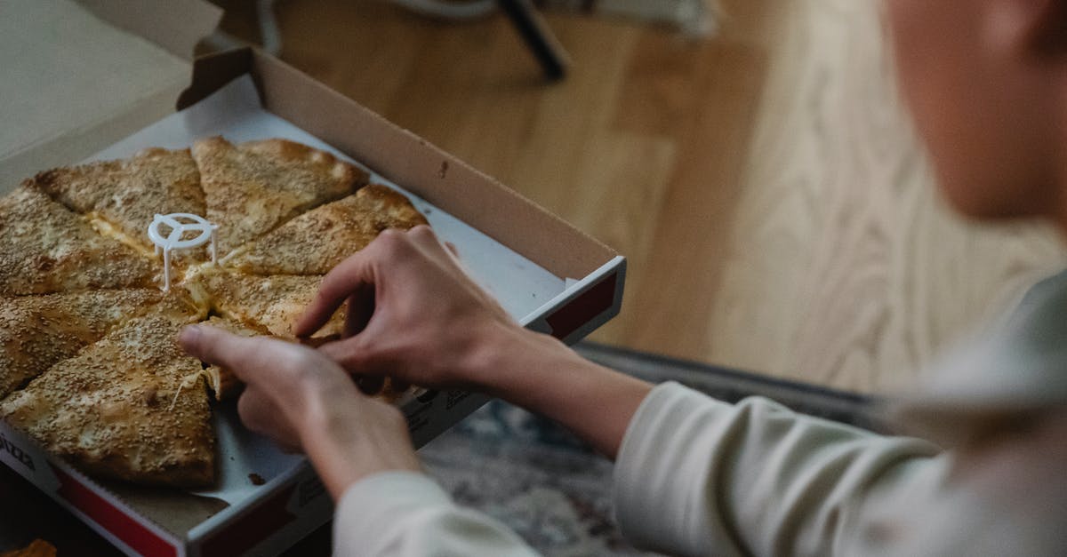 Late night buses from Helsinki airport to Turku in December? - From above crop anonymous person taking slice of delicious pizza from carton box on table spending evening at home Late night buses from Helsinki airport to Turku in December? - From above crop anonymous person taking slice of delicious pizza from carton box on table spending evening at home