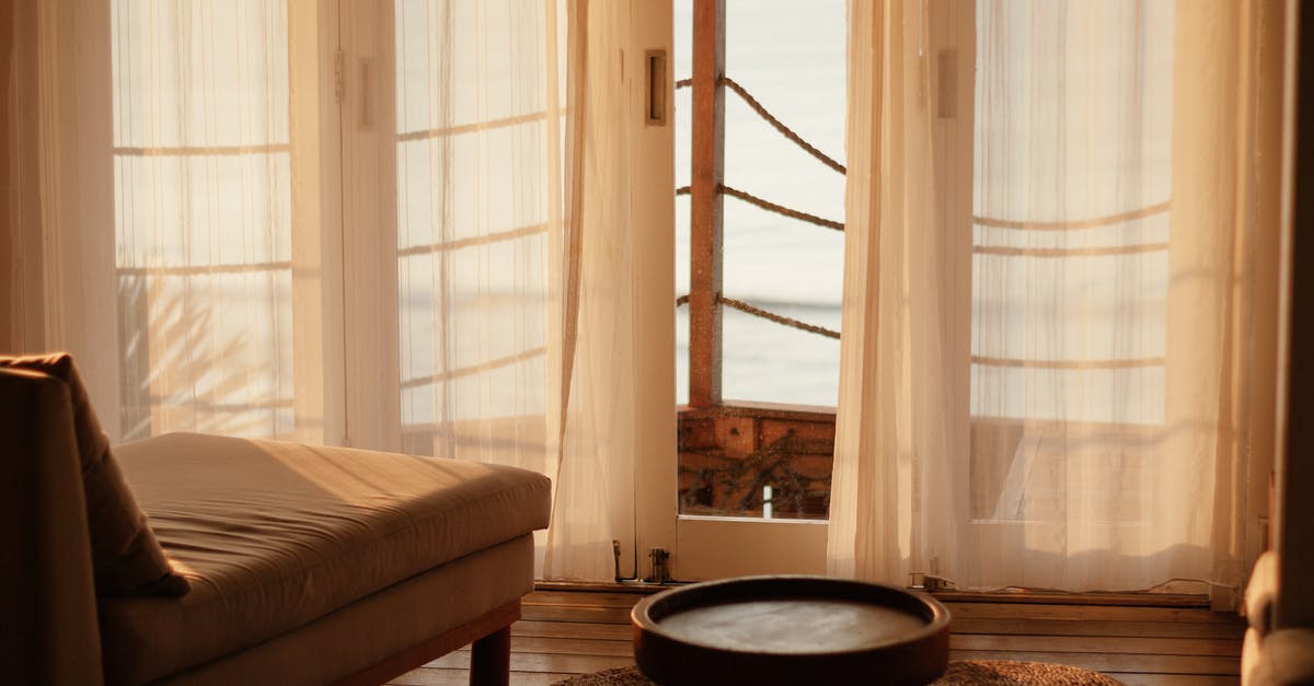 Leaving belongings in a capsule hotel - Black Round Table Near White Window Curtain Leaving belongings in a capsule hotel - Black Round Table Near White Window Curtain