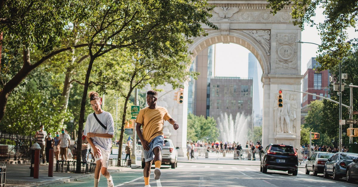 Length of stay USA B-1/B-2 visas - Trendy diverse male teens skateboarding on city street in sunlight Length of stay USA B-1/B-2 visas - Trendy diverse male teens skateboarding on city street in sunlight