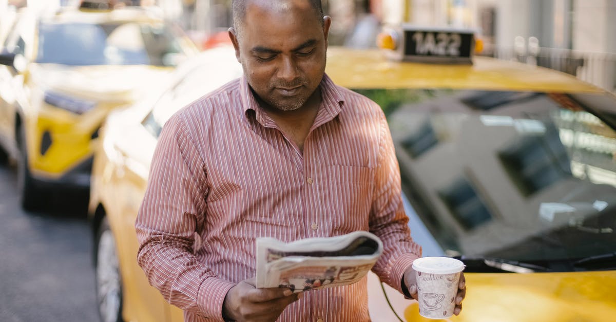 Lisbon Taxi: is it OK to take one Taxi for 2 adults and 3 kids? - Man with coffee and newspaper near cab Lisbon Taxi: is it OK to take one Taxi for 2 adults and 3 kids? - Man with coffee and newspaper near cab