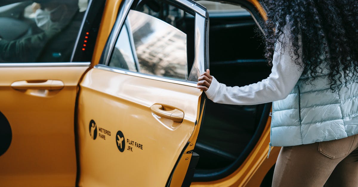 Long distance (16 hours) car trip with rental car and driver - Anonymous African American woman getting into cab parked on street Long distance (16 hours) car trip with rental car and driver - Anonymous African American woman getting into cab parked on street