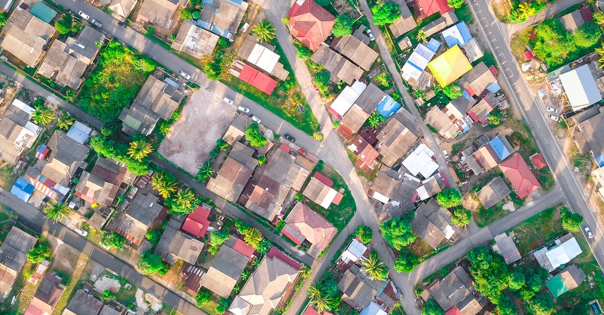 Long distance relationship: UK resident staying in Germany for 6 months? [closed] - Drone view of small multi colored private houses and verdant trees surrounded by long narrow roads in daylight in summertime