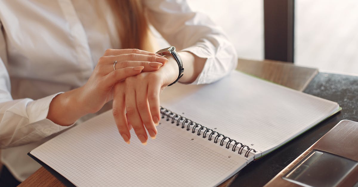 Long wait time for Schengen visa at NYC Swiss visa desk - Faceless crop female entrepreneur checking time while working with papers Long wait time for Schengen visa at NYC Swiss visa desk - Faceless crop female entrepreneur checking time while working with papers