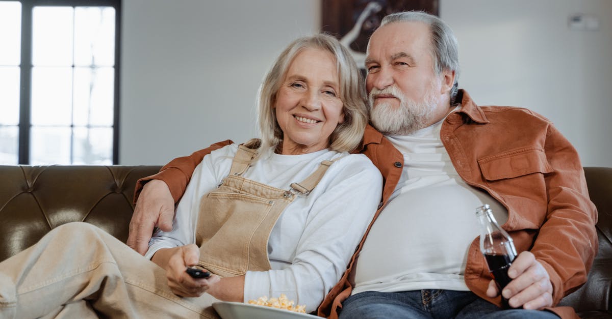 Longer EU stay for retired couple - Man and Woman Sitting on Couch Longer EU stay for retired couple - Man and Woman Sitting on Couch