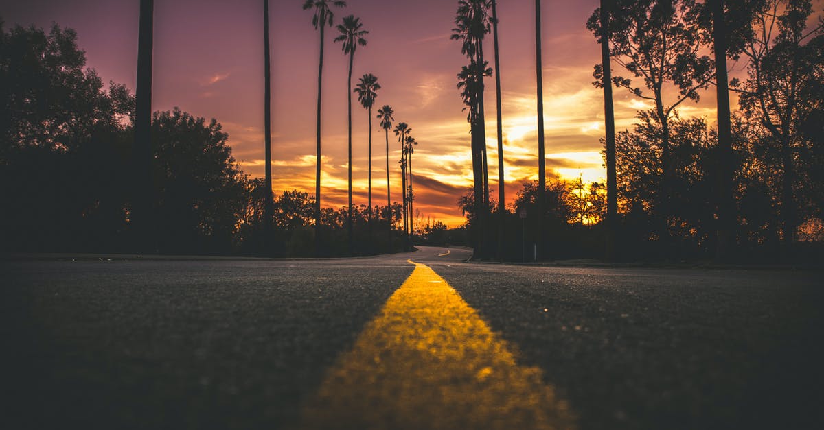 Longest distance ordinary road sign? - Road in City during Sunset