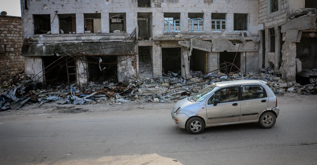 Longest uninhabited road segments - Automobile parked on road near old demolished house with broken windows and remains of building in poor district of town Longest uninhabited road segments - Automobile parked on road near old demolished house with broken windows and remains of building in poor district of town