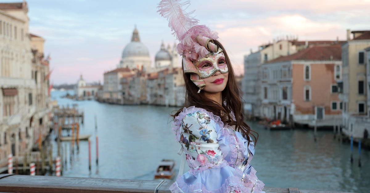 Long-life SIM cards in Europe - Side view of unrecognizable woman in magnificent costume and gorgeous Venetian mask with feathers standing on bridge in middle of Grand canal against background of cathedral of Santa Maria della Salute in Venice in Italy and looking at camera Long-life SIM cards in Europe - Side view of unrecognizable woman in magnificent costume and gorgeous Venetian mask with feathers standing on bridge in middle of Grand canal against background of cathedral of Santa Maria della Salute in Venice in Italy and looking at camera