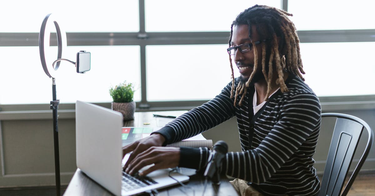 Long-term visa for Schengen for American(s)? - Woman in Black and White Striped Long Sleeve Shirt Using Macbook Air on Brown Wooden Table Long-term visa for Schengen for American(s)? - Woman in Black and White Striped Long Sleeve Shirt Using Macbook Air on Brown Wooden Table