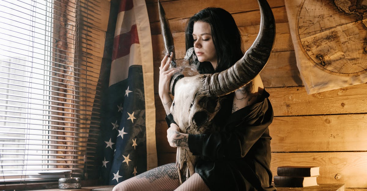 Looking for a book on hiking trails in USA written by an African American woman [closed] - Young female smoking cigarette and embracing big horned animal skull