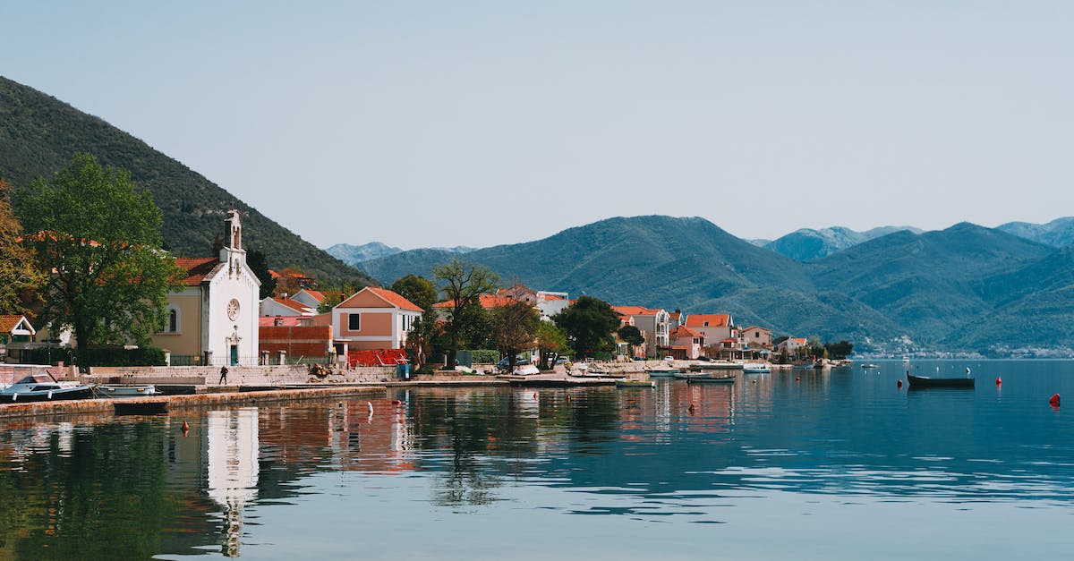 Looking for a small scenic beach town village in Spain or Portugal [closed] - Picturesque scenery of small coastal town located on hilly lake shore covered with lush greenery