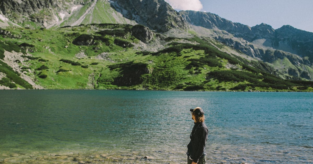 Looking for a very last minute adventure trip (5th -13th May) [closed] - A Man in Black Long Sleeves Standing Near the Lake while Looking at the Mountain