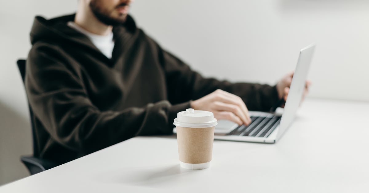 Looking for an adaptor to use my computer from France in Uruguay - Man in Black Sweater Using Macbook Pro