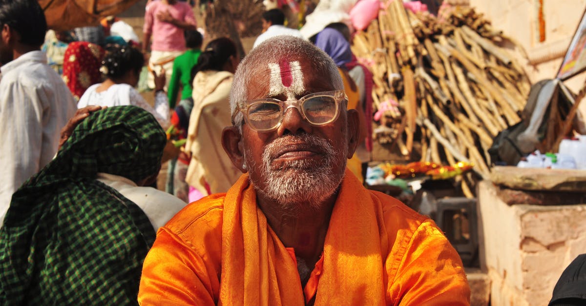 Lost old Indian passport. How to receive Indian Visa with American passport [closed] - Close-Up Shot of an Elderly Man in Orange Robe 