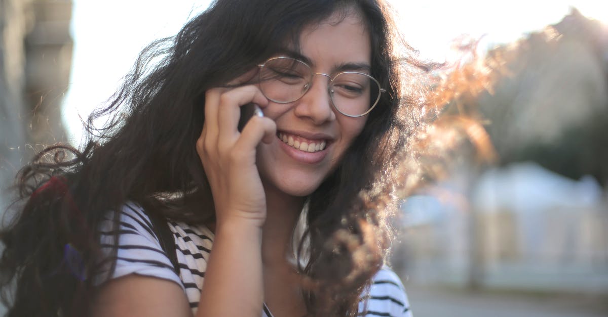 Lounge access when flying from Chongqing to Hong Kong? - Cheerful young woman making phone call on street Lounge access when flying from Chongqing to Hong Kong? - Cheerful young woman making phone call on street