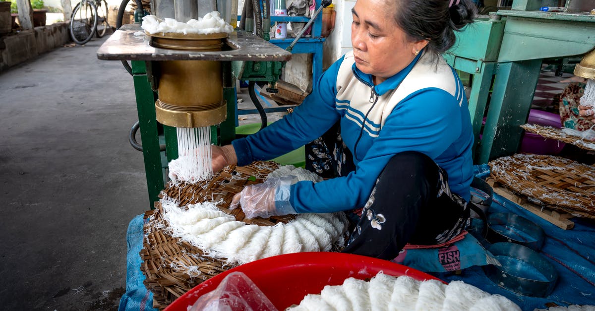Machine readable zone missing from Vietnam visa. Is this going to be a problem? - Ethnic lady making noodle on machine in factory