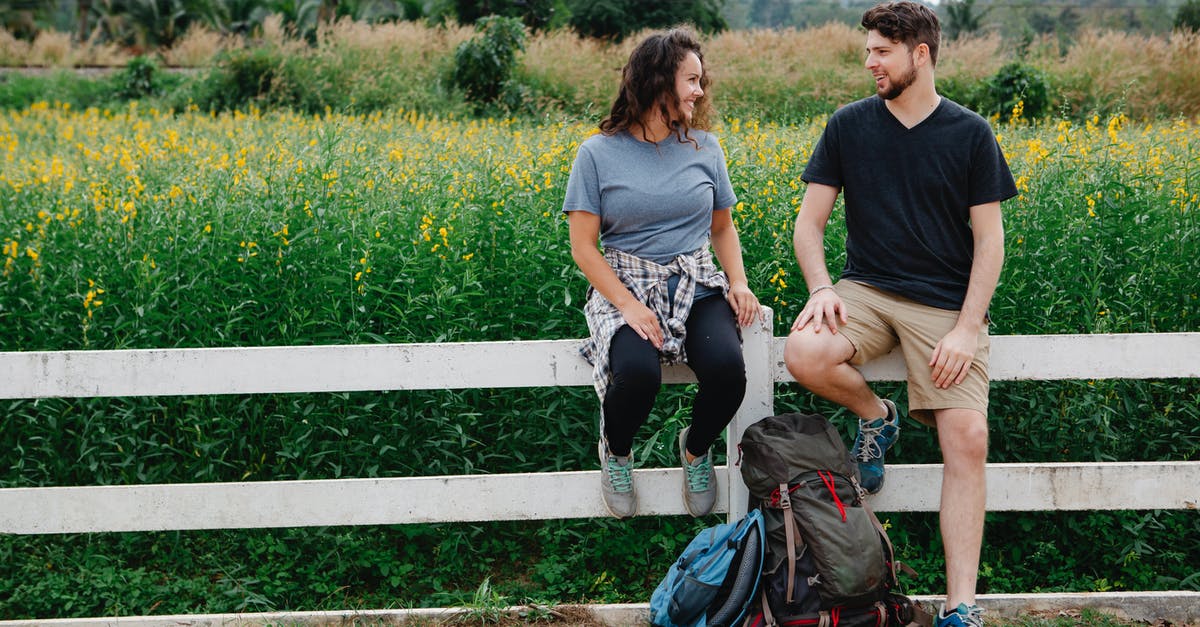 Machu Pichhu/Cusco four days DIY hiking trips suggestions [closed] - Romantic young couple resting on wooden fence near blooming lush meadow and chatting during hiking trip in countryside