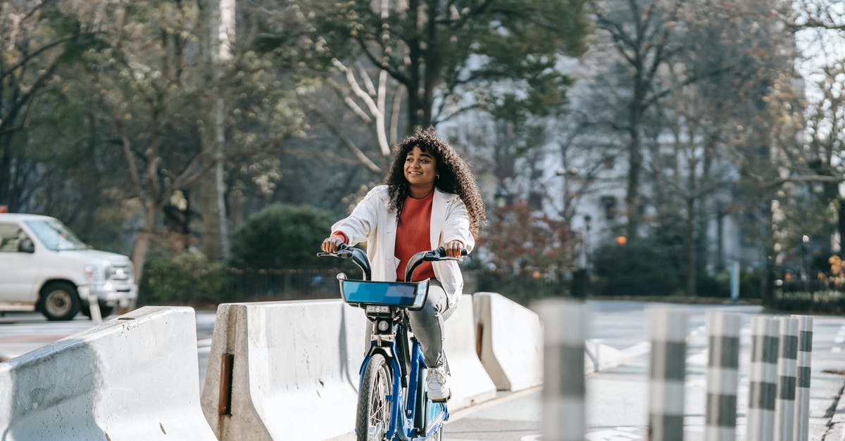 Madagascar in Dec/Jan, how bad is the rainy season? - Cheerful black woman riding bicycle on city street
