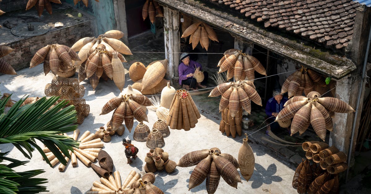 make schengen visa outside your origin country/homeland - From above of people sitting and making bamboo fish traps while working on local bazaar in Vietnam in daylight make schengen visa outside your origin country/homeland - From above of people sitting and making bamboo fish traps while working on local bazaar in Vietnam in daylight