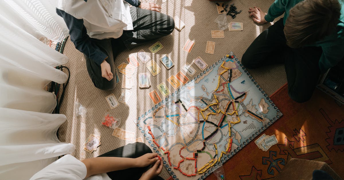 Managing SIM cards from multiple countries - Man in White Button Up Shirt and Black and White Plaid Pants Sitting on Floor Managing SIM cards from multiple countries - Man in White Button Up Shirt and Black and White Plaid Pants Sitting on Floor