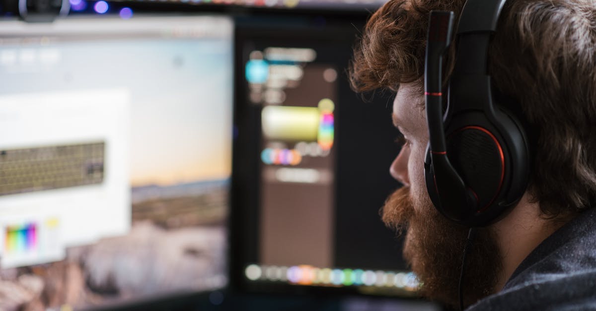 Managing SIM cards from multiple countries - Crop man in headphones working on computer Managing SIM cards from multiple countries - Crop man in headphones working on computer