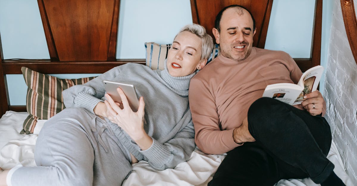 Married name on easyjet booking - Happy middle aged multiethnic couple cuddling while lying on comfortable bed together with book and tablet during lazy weekend at home Married name on easyjet booking - Happy middle aged multiethnic couple cuddling while lying on comfortable bed together with book and tablet during lazy weekend at home