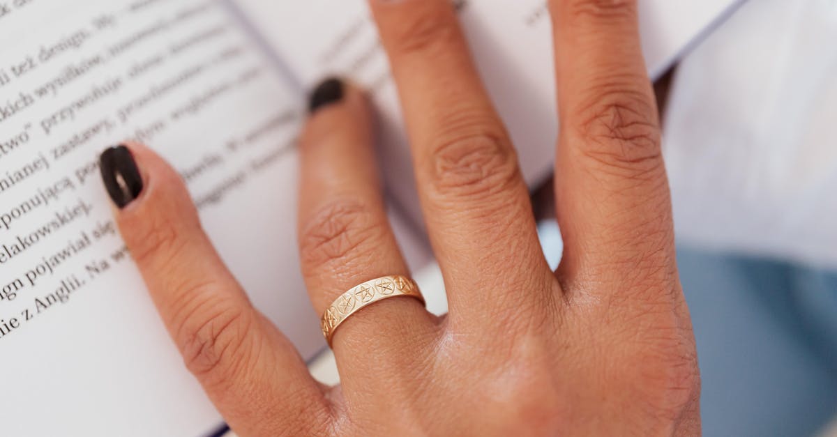 Married name on easyjet booking - Closeup hand of faceless woman with ring on nameless finger paging book while resting at home Married name on easyjet booking - Closeup hand of faceless woman with ring on nameless finger paging book while resting at home