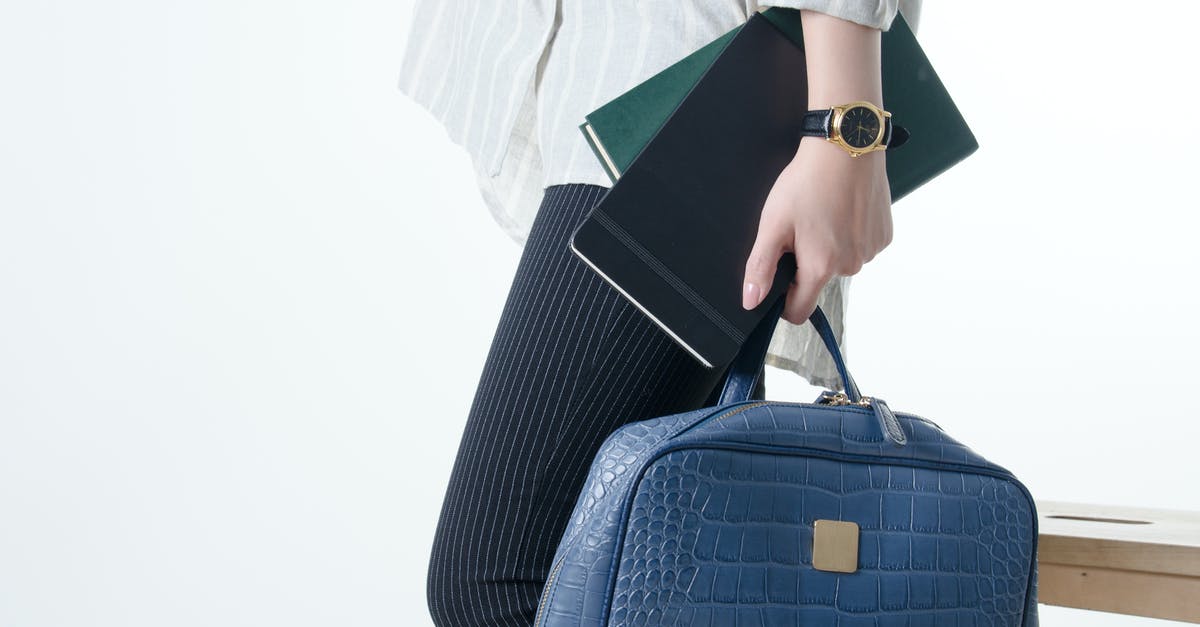 Maximum hand luggage volume? - Hand with Notebooks and Blue Hand Bag Maximum hand luggage volume? - Hand with Notebooks and Blue Hand Bag