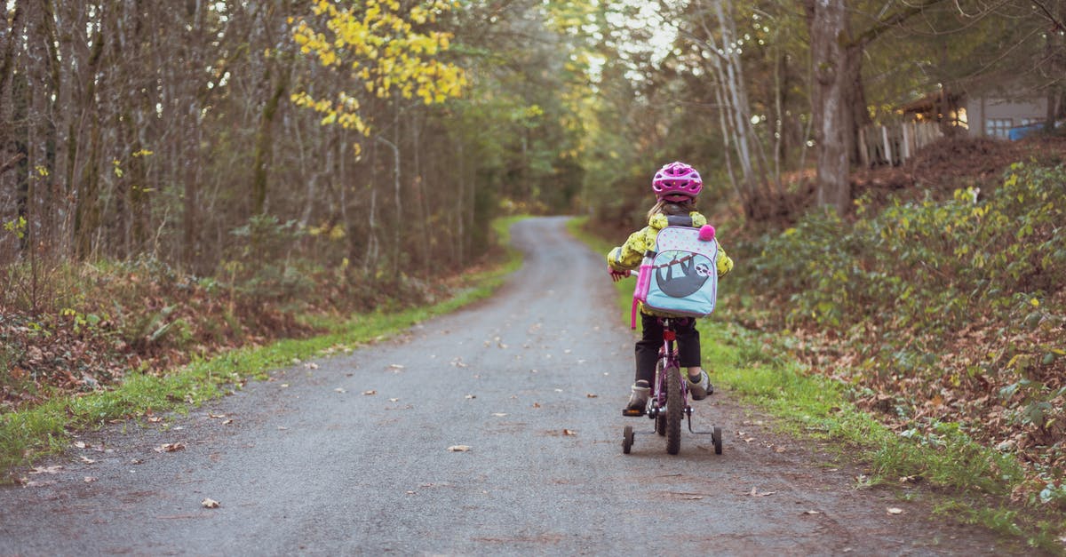 May kids ride in the back of a 5th Wheel in the US? - Toddler Riding Bicycle on Road